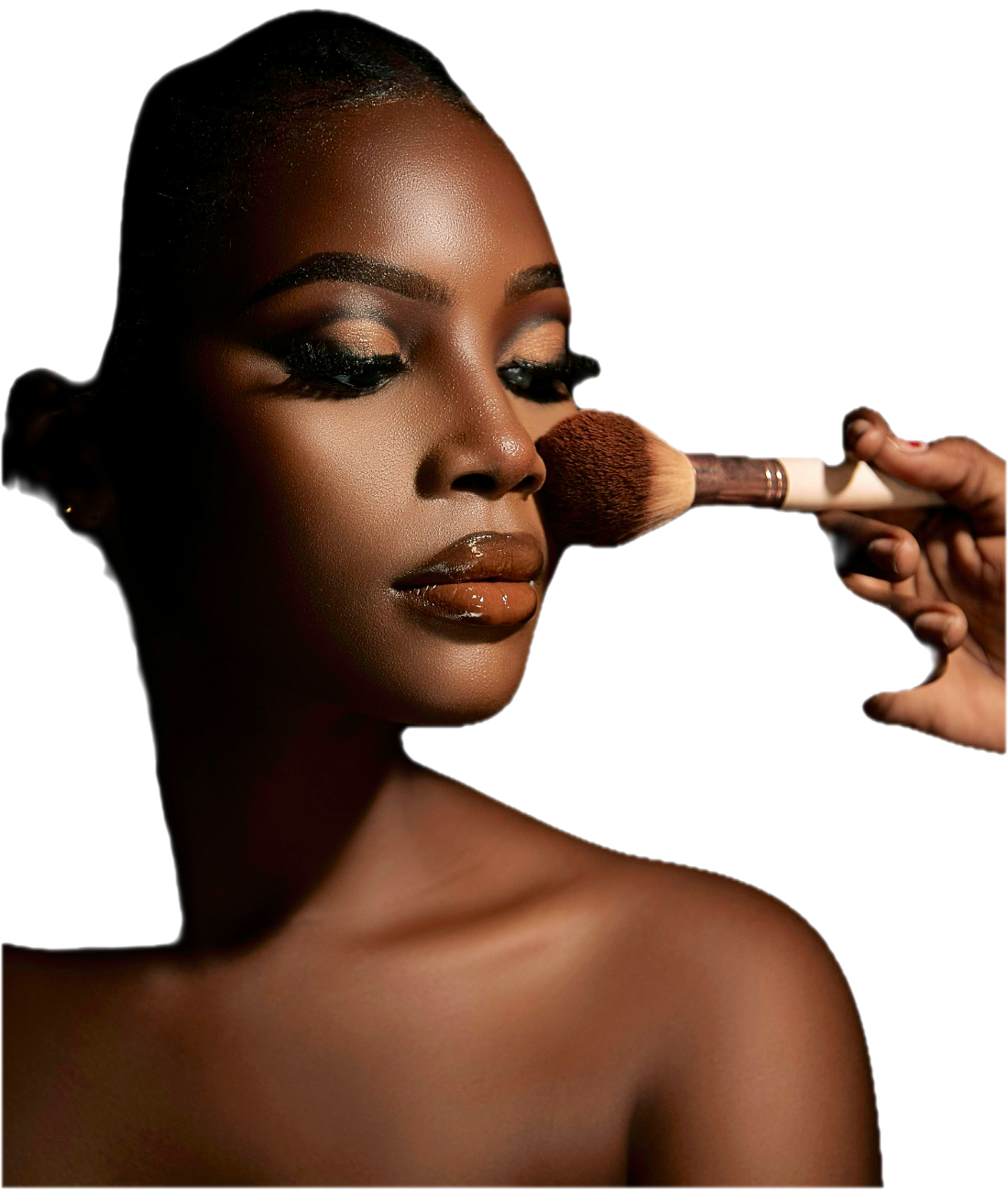 A client getting glam makeup applied with a blush brush